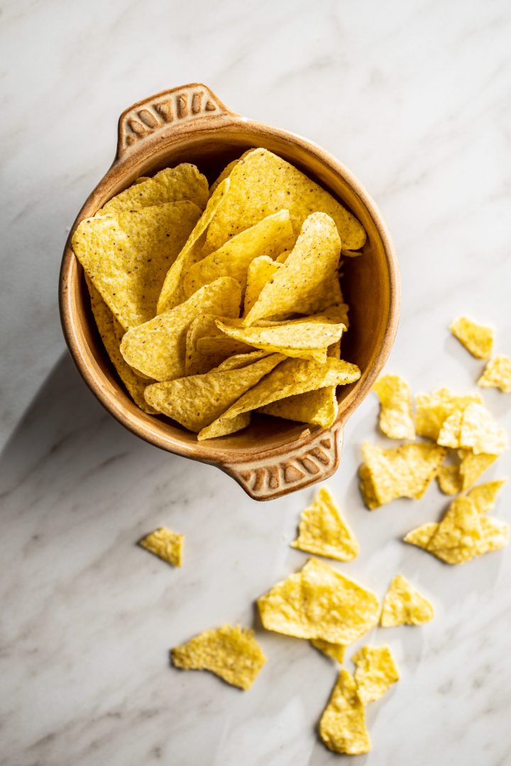 Tortilla chips. Mexican nacho chips in bowl. Top view.
